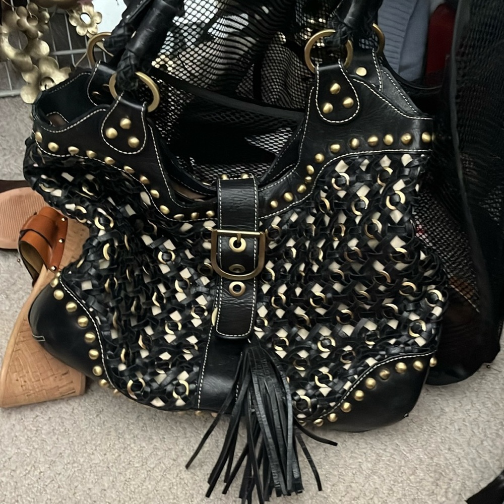 Rafe black leather and brass bag with magnetic closure, fringe accent. Solid